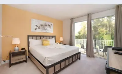 a bedroom with a bed and a balcony at 3 bedrooms pool home Retreat Close to Disney in Orlando