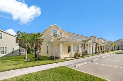 a row of houses on a street with palm trees at 3 bedrooms pool home Retreat Close to Disney in Orlando