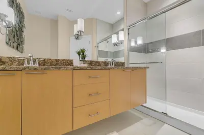 a bathroom with two sinks and a shower at 3 bedrooms pool home with clubhouse amenities Retreat in Orlando