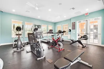a gym with bikes and exercise equipment in a room at Affordable Disney pool home 3 Bed 3 bath in Orlando