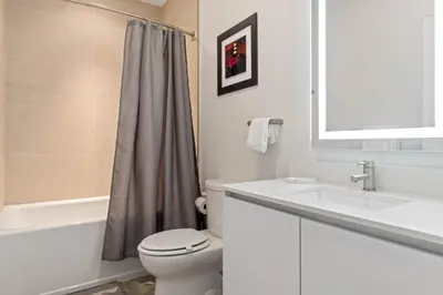 a white bathroom with a toilet and a sink at 3 bedrooms pool home Hidden Forest Resort Amenities in Orlando