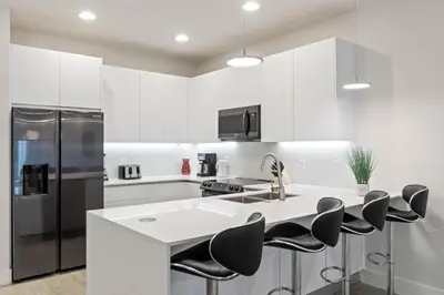 a kitchen with a white counter and black appliances at 3 bedrooms pool home Hidden Forest Resort Amenities in Orlando