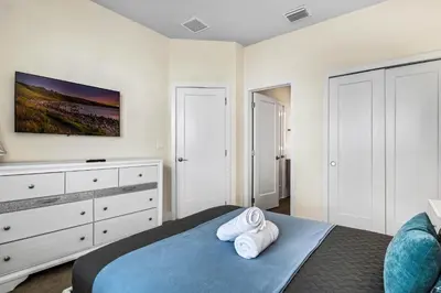 a bedroom with a bed with two towels at 3 bedrooms pool home Hidden Forest Resort Amenities in Orlando