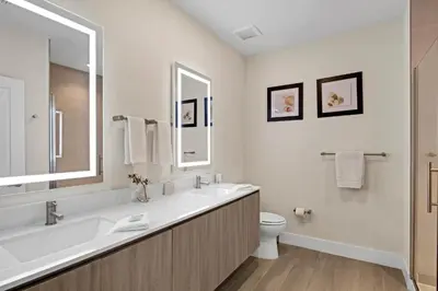 a white bathroom with a sink and a toilet at 3 bedrooms pool home Hidden Forest Resort Amenities in Orlando