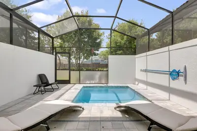 a swimming pool in a house with a glass roof at 3 bedrooms pool home Hidden Forest in Orlando