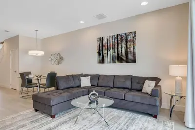 a living room with a couch and a table at 3 bedrooms pool home Hidden Forest in Orlando