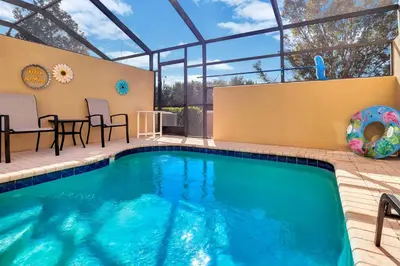 a swimming pool in a patio with a table and chairs at WH7642SKC 3 beds pool home Gated resort in Orlando
