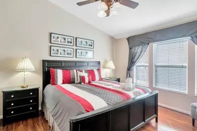 a bedroom with a bed and a ceiling fan at WH7642SKC 3 beds pool home Gated resort in Orlando