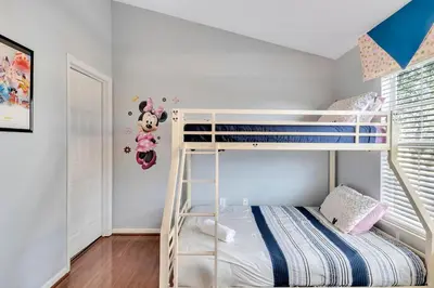 a bedroom with bunk beds with a mickey mouse wall at WH7642SKC 3 beds pool home Gated resort in Orlando