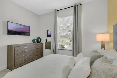 a white bedroom with a large bed and a window at 3 bedrooms pool home with clubhouse amenities Retreat in Orlando