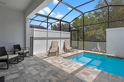 a swimming pool in a house with windows at 3 bedrooms pool home Hidden Forest Resort Amenities in Orlando