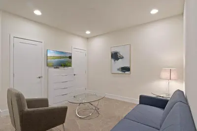 a living room with a blue couch and two chairs at 3 bedrooms pool home Hidden Forest Resort Amenities in Orlando