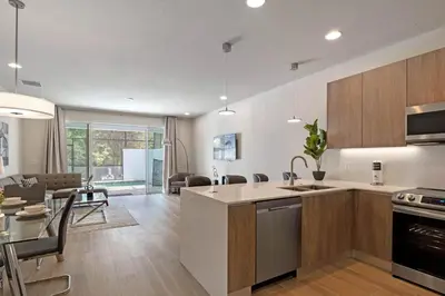 an open kitchen and living room with a dining room at 3 bedrooms pool home Hidden Forest Resort Amenities in Orlando