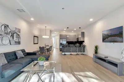 a living room with a blue couch and a table at 3 bedrooms pool home Hidden Forest Resort Amenities in Orlando