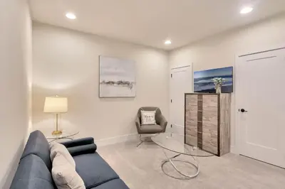 a living room with a blue couch and a chair at 3 bedrooms pool home Hidden Forest Resort Amenities in Orlando