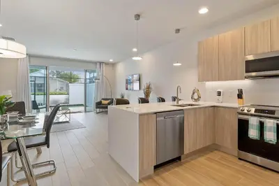 a kitchen and living room with a table and a dining room at 3 bedrooms pool home Hidden Forest Resort Amenities in Orlando