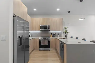 a kitchen with a refrigerator and a stove top oven at 3 bedrooms pool home Hidden Forest Resort Amenities in Orlando