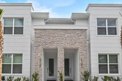 a white house with a brick at 3 bedrooms pool home Hidden Forest Resort Amenities in Orlando