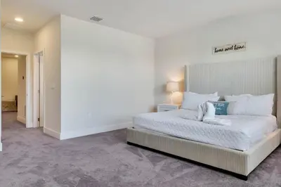 a bedroom with a large white bed in a room at 3 bedrooms pool home Hidden Forest Resort Amenities in Orlando