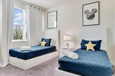 a bedroom with two beds and a window at 3 bedrooms pool home Hidden Forest Resort Amenities in Orlando