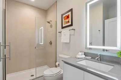 a bathroom with a toilet and a sink and a shower at 3 bedrooms pool home Hidden Forest Resort Amenities in Orlando