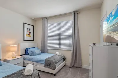 a bedroom with two beds and a window at 3 bedrooms pool home Hidden Forest Resort Amenities in Orlando
