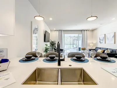 a kitchen with a sink and a living room at 3 bedrooms pool home Hidden Forest Resort Amenities in Orlando