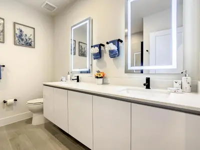 a white bathroom with a sink and a toilet at 3 bedrooms pool home Hidden Forest Resort Amenities in Orlando