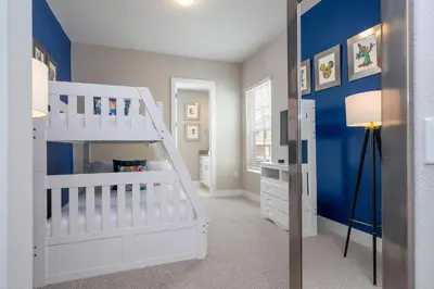 a bedroom with a white bunk bed and blue walls at Gorgeous 4 Suites DREAM Villa 5 min to Disney in Orlando