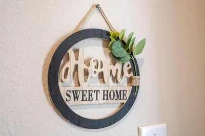 a sign that reads home sweet home hanging on a wall at Gorgeous 4 Suites DREAM Villa 5 min to Disney in Orlando