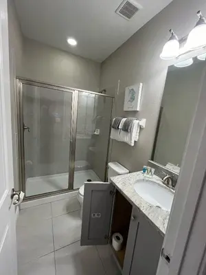 a bathroom with a shower and a sink and a toilet at Luxury 6 BR 6 Bath @Encore Resort Pool Spa Grill. in Orlando