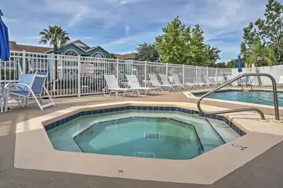 a swimming pool with lounge chairs and a swimming pool at Villa at Island Club in Kissimmee