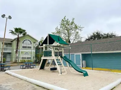 a playground with a slide in front of a building at Villa at Island Club in Kissimmee