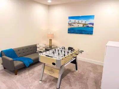 a living room with a chess game on a table at 3 bedrooms pool home Hidden Forest Resort Amenities in Orlando