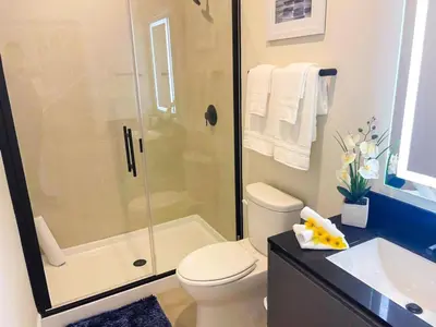 a bathroom with a shower and a toilet and a sink at 3 bedrooms pool home Hidden Forest Resort Amenities in Orlando