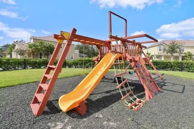 a playground with a slide and a ladder at 3 bedrooms pool home Hidden Forest Resort Amenities in Orlando