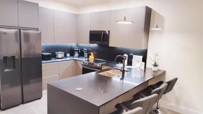 a kitchen with a stainless steel refrigerator and a counter at 3 bedrooms pool home Hidden Forest Resort Amenities in Orlando