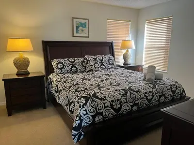 a bedroom with a bed and two night stands with lamps at S890SB - 12 guests - 6 beds in Kissimmee