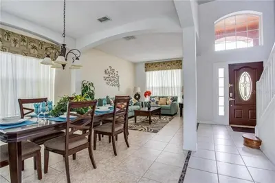 a dining room and living room with a table and chairs at S890SB - 12 guests - 6 beds in Kissimmee