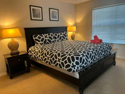 a bedroom with a black and white bed and two lamps at S890SB - 12 guests - 6 beds in Kissimmee