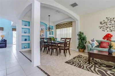a living room and dining room with a table and chairs at S890SB - 12 guests - 6 beds in Kissimmee