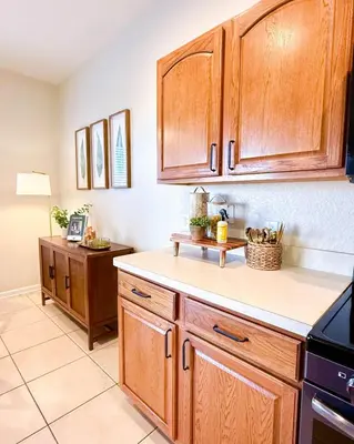 a kitchen with wooden cabinets and a counter top at WH7783TB-Windsor Hills- 10 guests - in Orlando