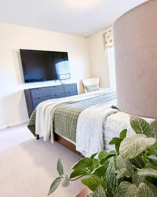 a bedroom with a bed with a tv on the wall at WH7783TB-Windsor Hills- 10 guests - in Orlando
