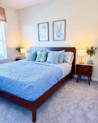 a bedroom with a blue bed with two lamps at WH7783TB-Windsor Hills- 10 guests - in Orlando