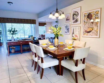 a dining room with a wooden table and white chairs at WH7783TB-Windsor Hills- 10 guests - in Orlando