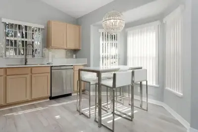 a kitchen with a table and some white chairs at IC8090ICB - Indian Creek Oasis in Kissimmee