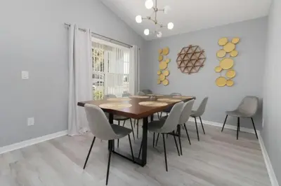 a dining room with a wooden table and chairs at IC8090ICB - Indian Creek Oasis in Kissimmee