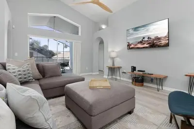 a living room with a couch and a table at IC8090ICB - Indian Creek Oasis in Kissimmee