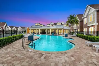 a swimming pool in front of a house at Brand New 3 Suites 5 min to Disney in Orlando