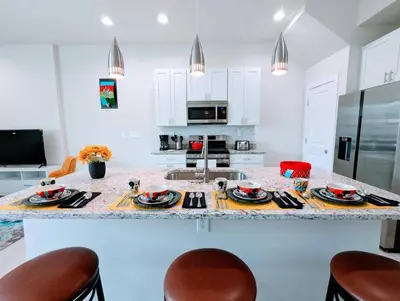 a kitchen with a large island with a counter top at Brand New 3 Suites 5 min to Disney in Orlando